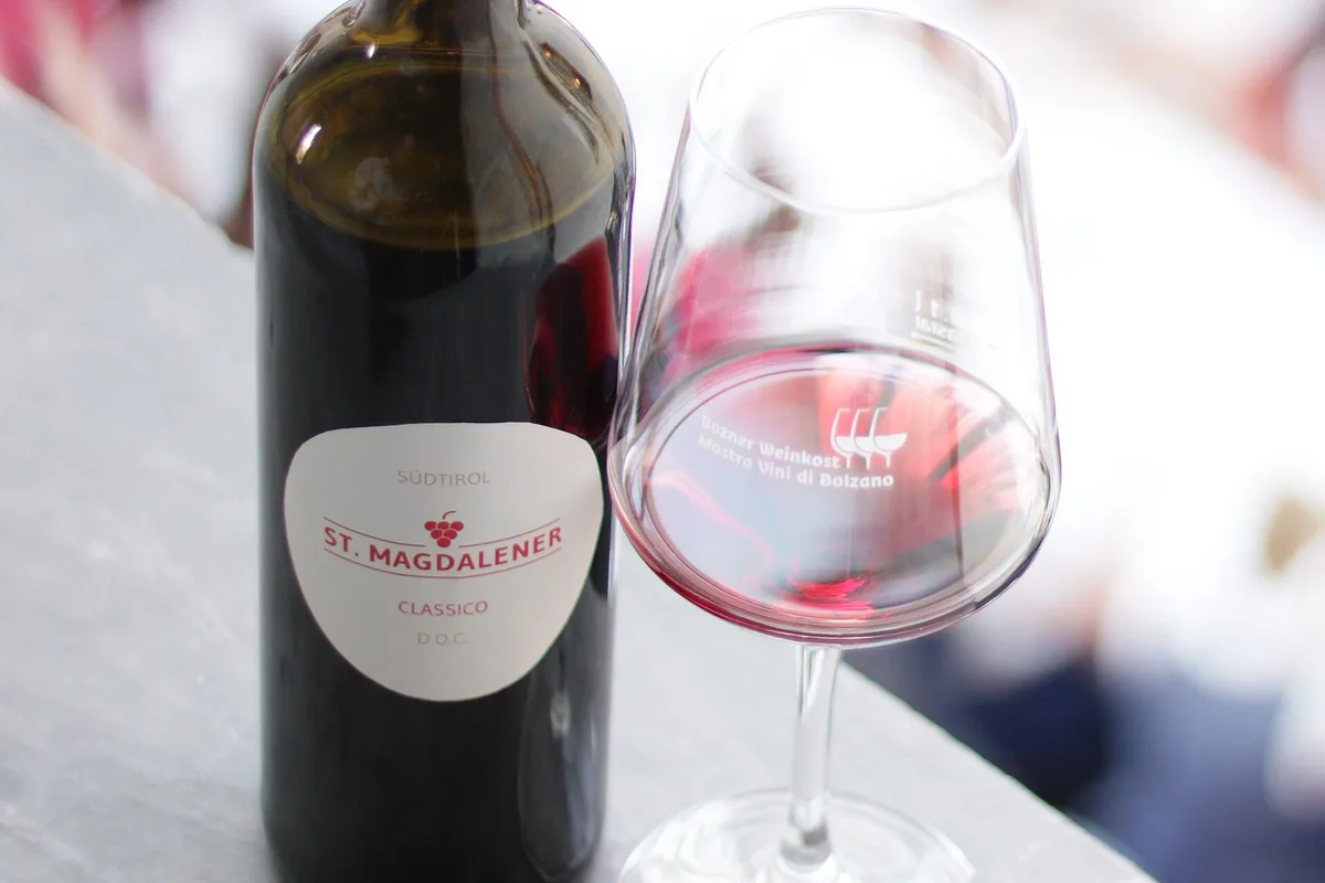 A glass of red wine being tasted